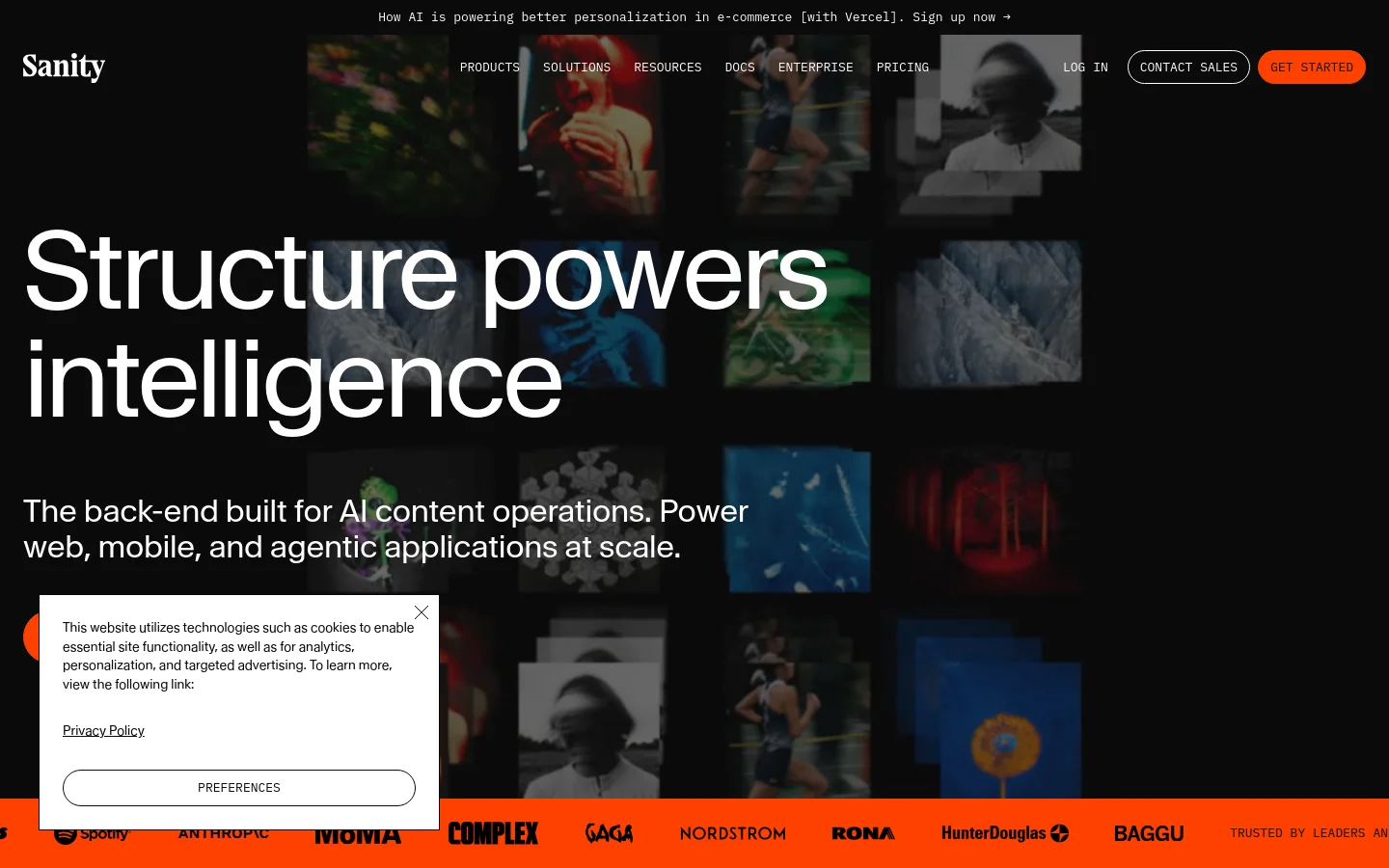 The desktop homepage features a dark theme with a large headline reading 'Structure powers intelligence' over a background of muted, grid-like imagery. A navigation bar at the top includes links for Products, Solutions, and Resources, alongside 'Contact Sales' and 'Get Started' buttons. Below the hero section, a row of company logos is displayed under the heading 'Trusted by leaders and innovators'.