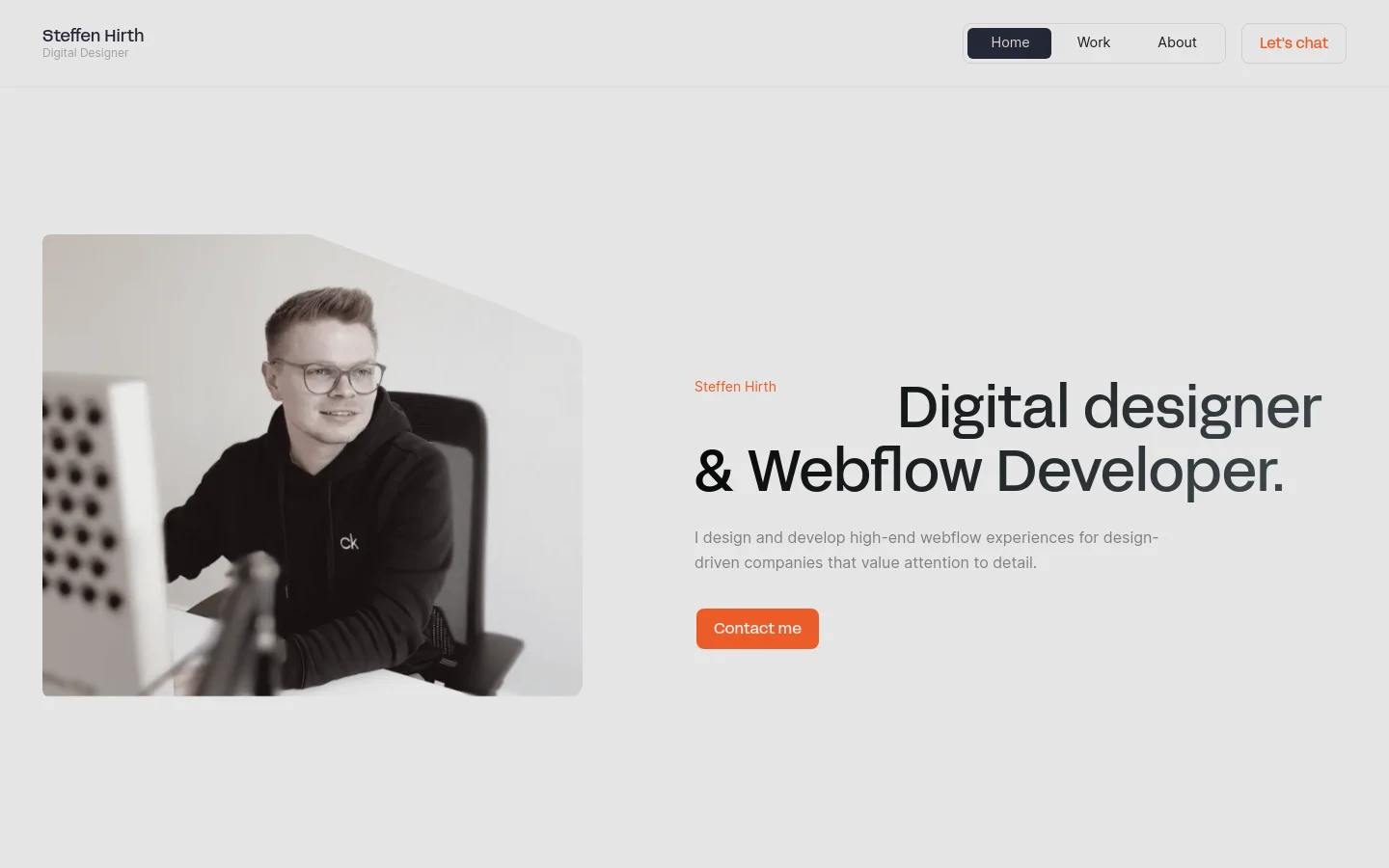 Desktop homepage for Steffen Hirth, a digital designer and Webflow developer. The layout features a clean, light gray background with a large hero section containing a portrait of Steffen Hirth on the left and a bold headline, subtext, and an orange 'Contact me' call-to-action button on the right. A navigation bar at the top includes links for Home, Work, About, and a 'Let's chat' button, followed by a horizontal row of client logos.