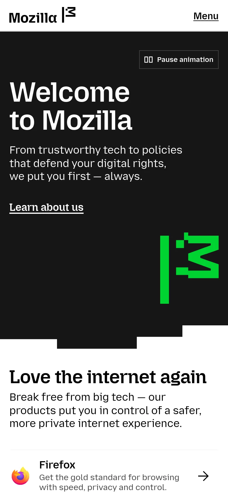 Mobile version of the Mozilla homepage featuring a stacked layout. The 'Welcome to Mozilla' headline and text are centered above the 'Learn about us' link, with the green geometric logo appearing below the text. The top navigation is replaced by a 'Menu' button.
