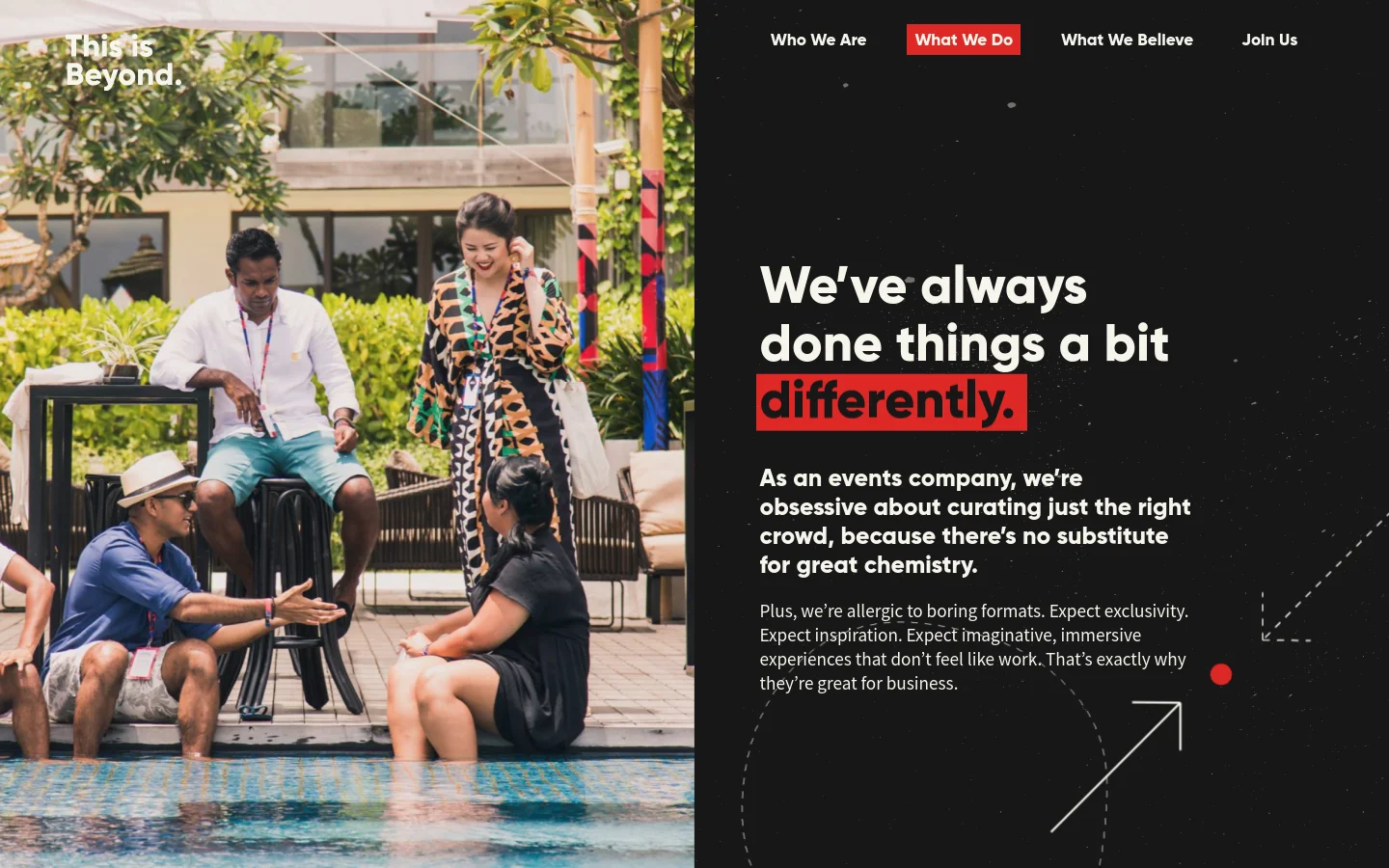 The desktop page features a split-screen layout with a large photograph of people socializing by a pool on the left and a black section with white and red text on the right. The headline reads 'We’ve always done things a bit differently' and is accompanied by a navigation menu at the top. The design uses a high-contrast color palette of black, white, and red.