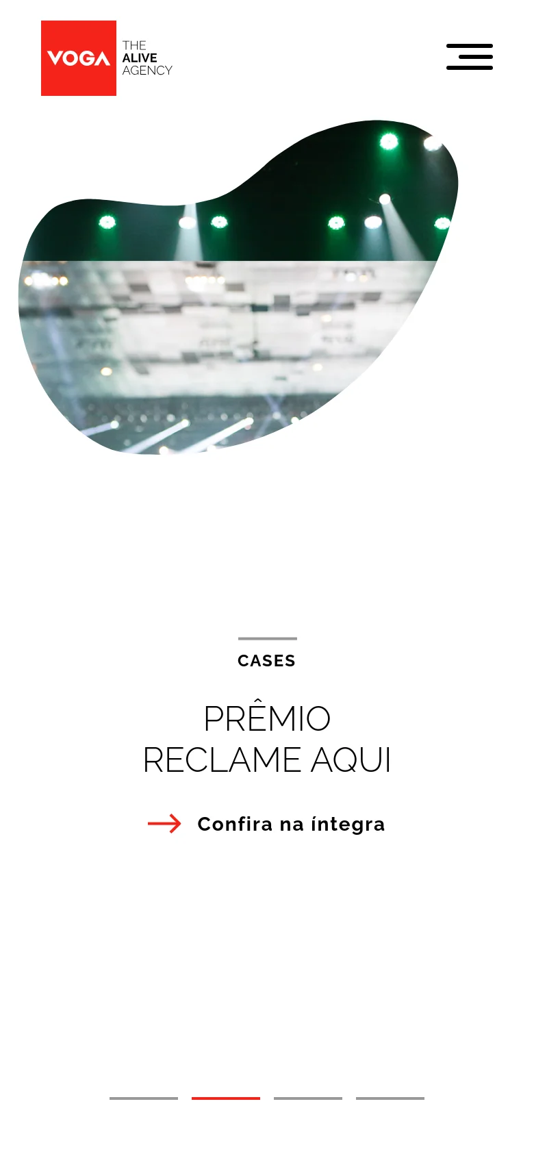 The mobile version uses a vertical layout with a hamburger menu icon at the top right and the Voga logo on the left. The organic-shaped image of the mascot is centered above the 'CASES' heading and the 'PRÊMIO RECLAME AQUI' title, with the red call to action link placed below the text.