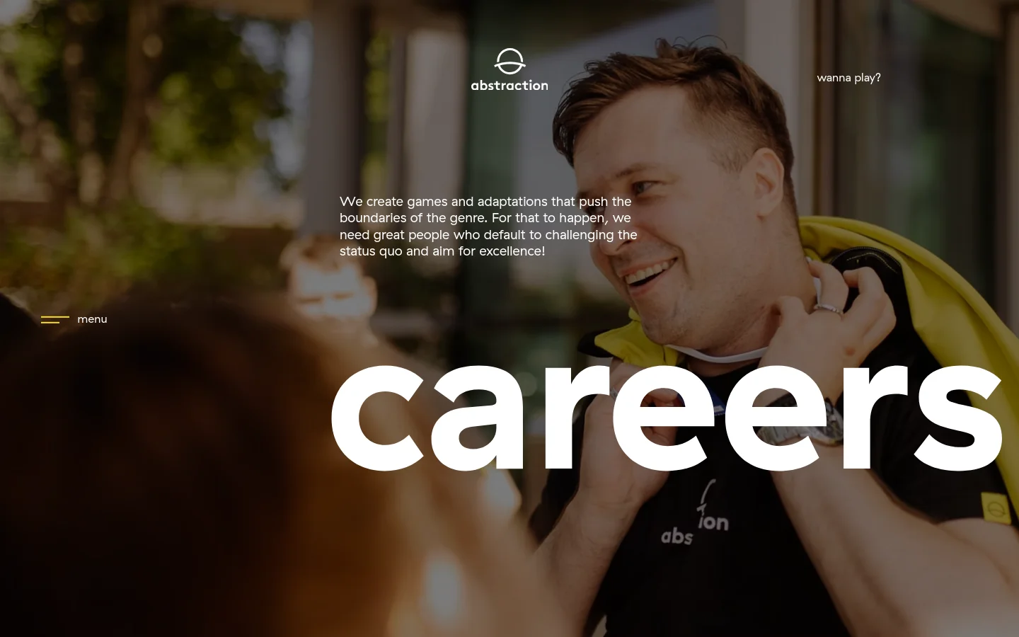 The desktop careers page features a large hero image of two people smiling, overlaid with a dark tint. The Abstraction logo is at the top center, with the word 'careers' in large white lowercase letters across the middle and a 'menu' link on the left.
