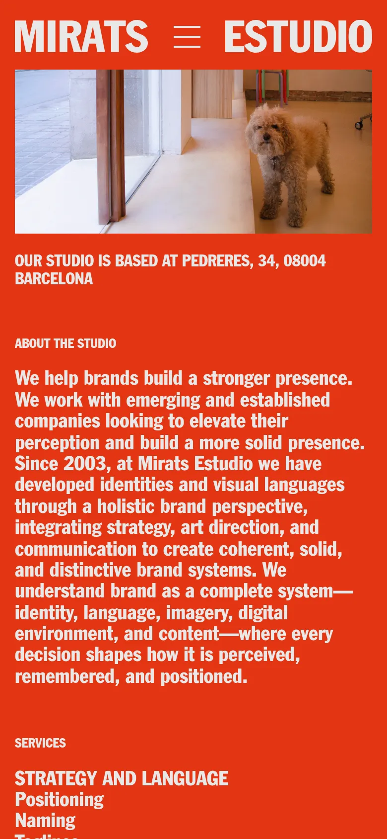 The mobile version uses a simplified layout with a hamburger menu icon next to the 'MIRATS ESTUDIO' logo. The hero image of the tan dog is centered above the studio's location and a detailed 'About the Studio' text section, all set against a solid orange background.