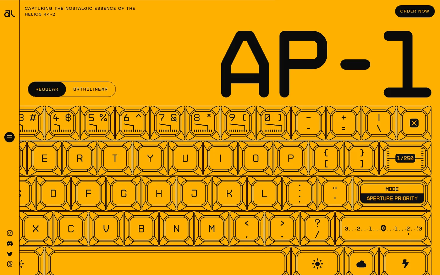 The desktop page features a vibrant mustard yellow background with large, bold black typography reading 'AP-1'. Below the header, a stylized graphic of a mechanical keyboard layout is displayed, featuring keycaps with technical photography markings like aperture and ISO settings. A black 'ORDER NOW' button is positioned in the top right corner.