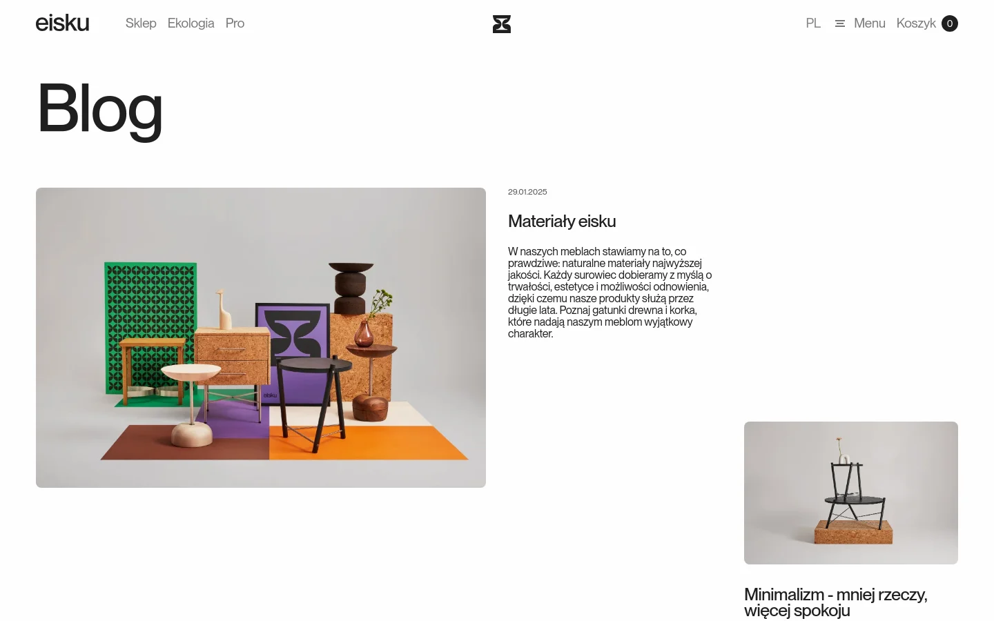 The desktop blog page features a minimalist white layout with a large 'Blog' heading. A featured article displays a wide landscape image of various colorful modern furniture pieces arranged on a geometric patterned floor, accompanied by a title, date, and descriptive text to the right.