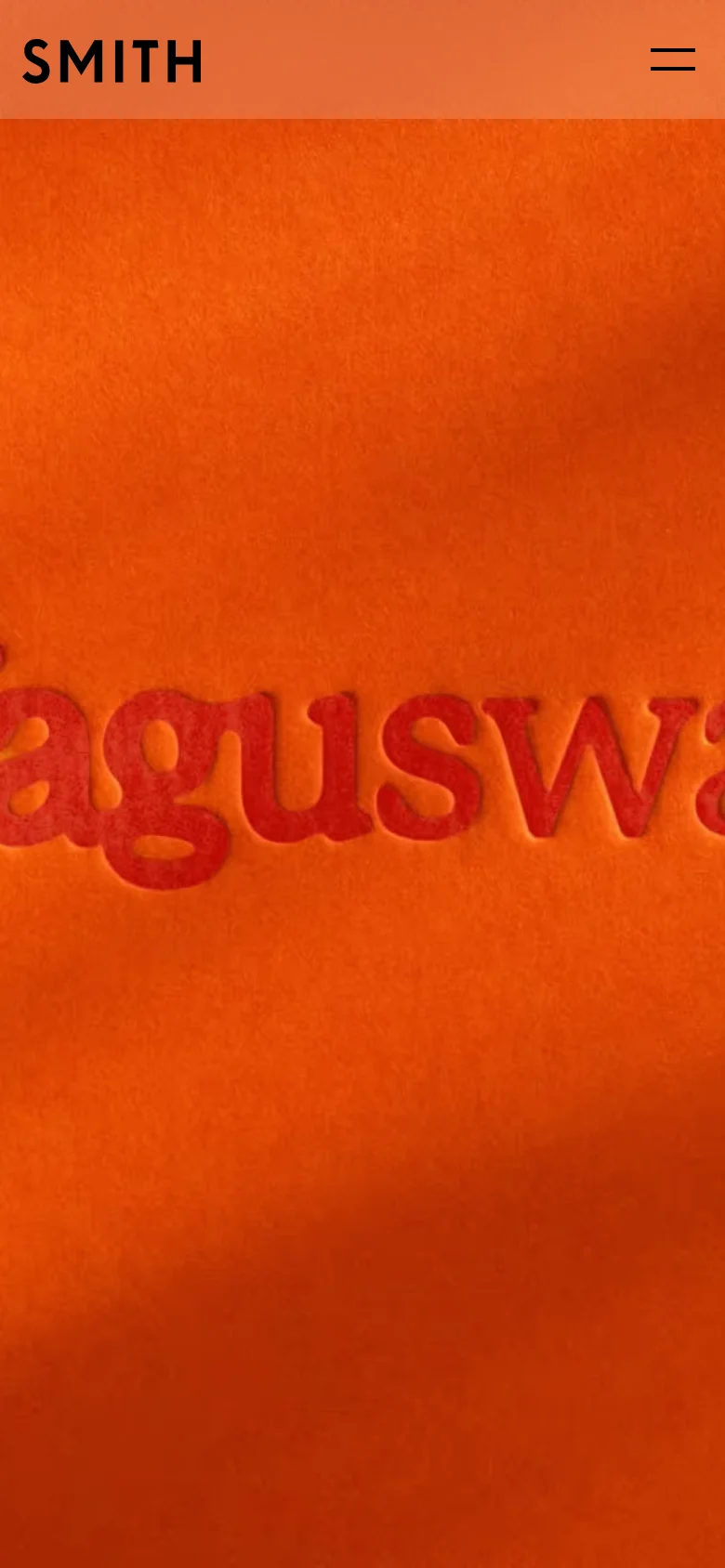 The mobile version simplifies the layout, showing only the 'SMITH' logo on the left and a two-line hamburger menu icon on the right against a terracotta-colored header. The hero section remains a large, textured orange area with the red embossed 'Vagusway' text, scaled to fit the narrower screen.