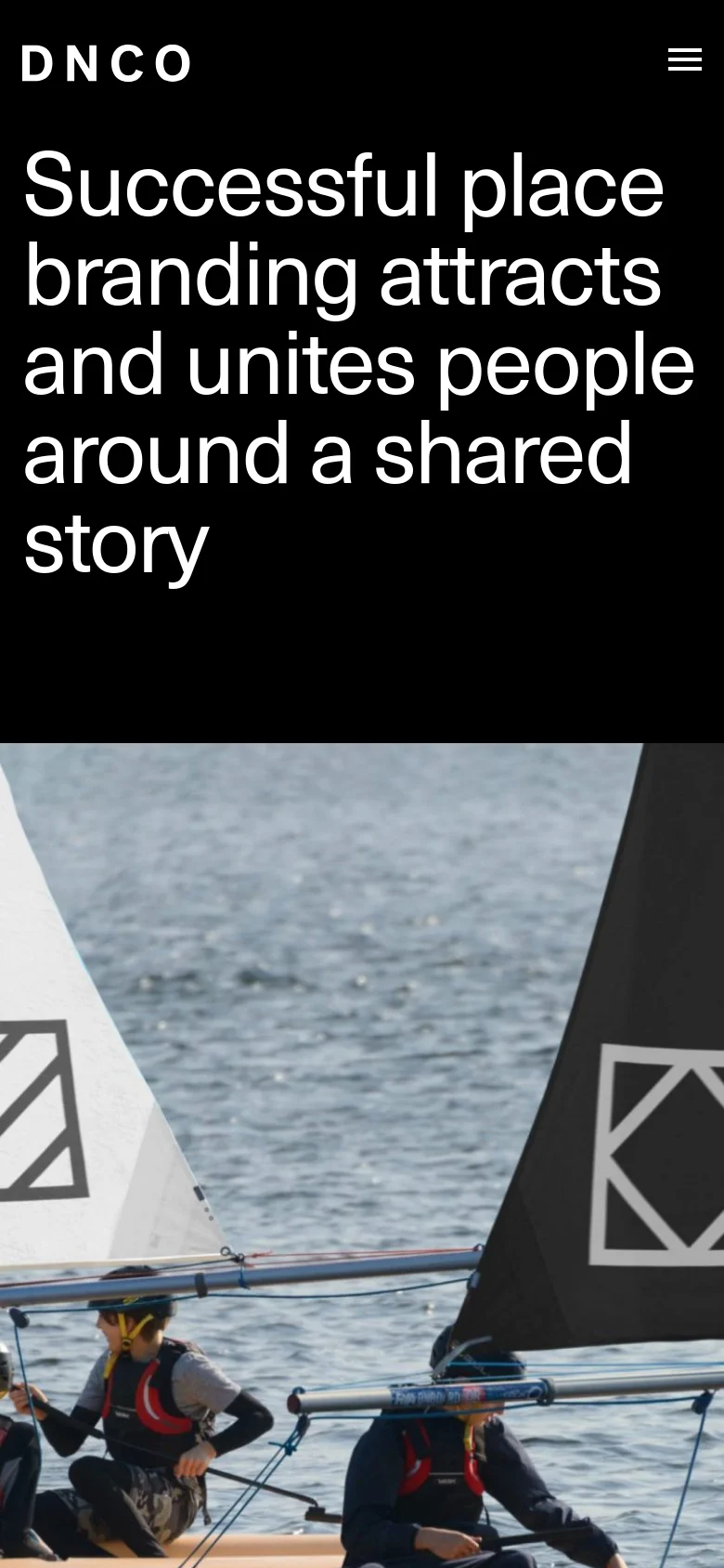 The mobile version displays a simplified dark header with the DNCO logo and a hamburger menu icon. The large white headline is stacked vertically to fit the narrow screen, followed by a cropped version of the hero image showing sailboats on the water.