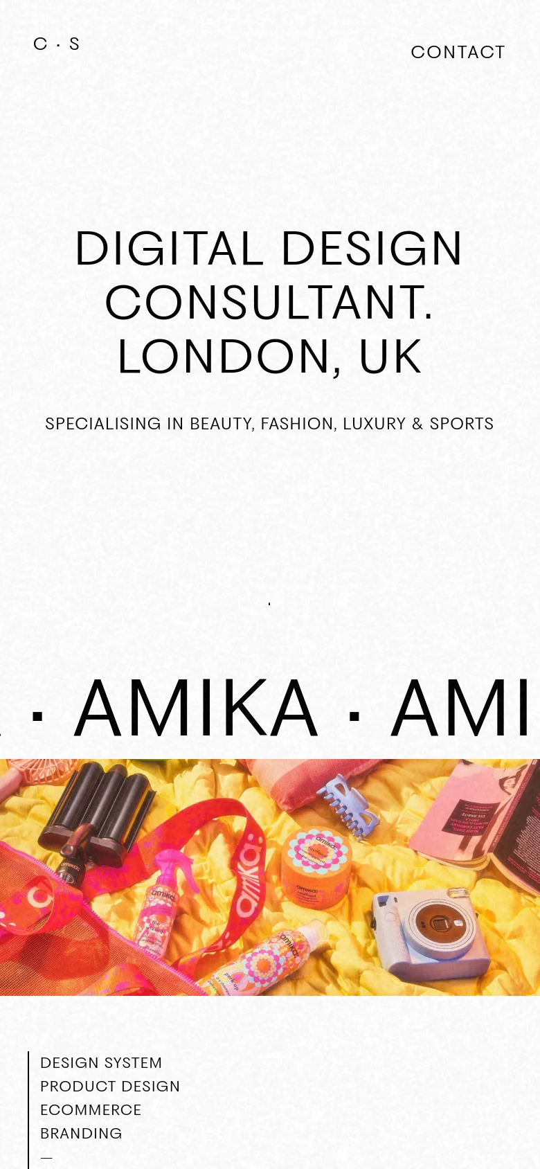 The mobile version maintains the minimalist white aesthetic but features a vertically stacked layout. The headline and subheadline are centered and scaled for a smaller screen, and the 'AMIKA' marquee text is partially visible at the bottom, transitioning into a project section with text details like 'DESIGN SYSTEM' and 'PRODUCT DESIGN'.