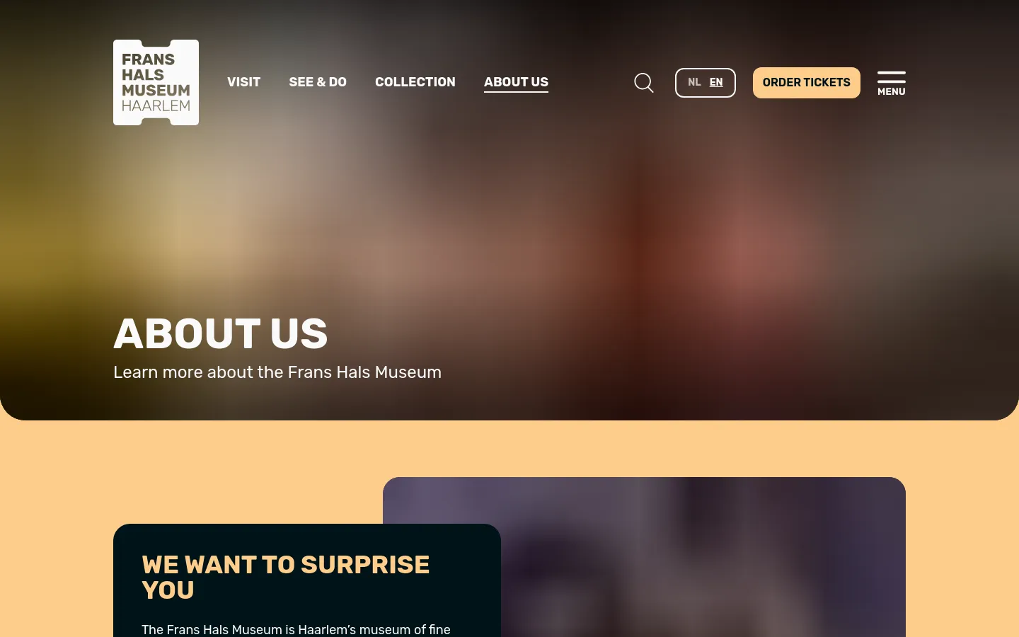 The desktop page features a large hero section with a blurred background and the headline 'ABOUT US'. Below, a tan-colored section contains a dark navy text box with the heading 'WE WANT TO SURPRISE YOU' and introductory text. The navigation bar at the top includes the museum logo, links for Visit, See & Do, Collection, and About Us, a search icon, language selector, and an 'ORDER TICKETS' button.