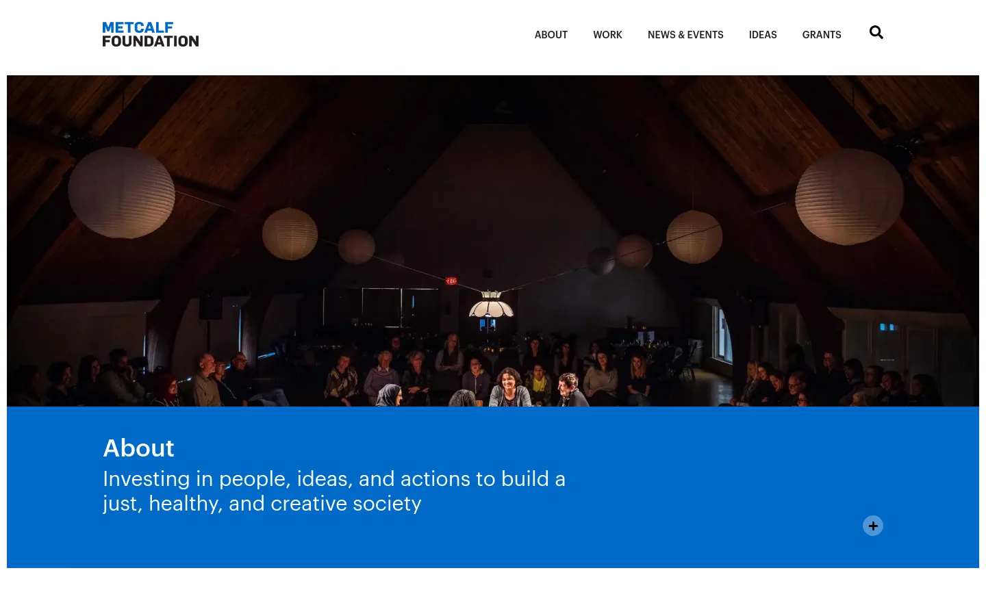 The desktop About page features a large hero image of an audience in a dimly lit theater with hanging paper lanterns. Below the image, a bright blue banner contains the heading 'About' and the foundation's mission statement, with a navigation menu at the top including links for About, Work, News & Events, Ideas, and Grants.