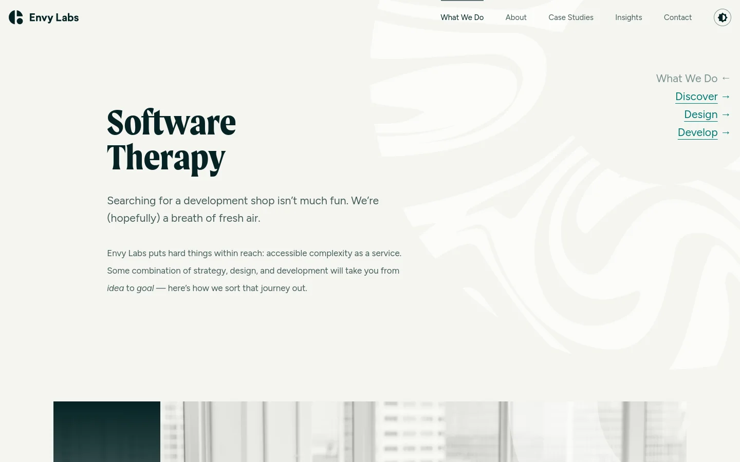 The desktop page features a clean, minimalist layout with a white background and dark text. A large headline reads 'Software Therapy' next to a subtle, light gray abstract wave pattern, with a navigation menu at the top and links for Discover, Design, and Develop on the right. Below the hero section, a large photograph shows three developers working at their stations in a bright office.
