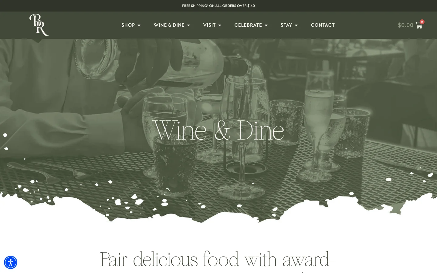 The desktop page features a large hero image of wine being poured into glasses with a dark green overlay and the headline 'Wine & Dine' in white serif text. A navigation menu at the top includes links for Shop, Wine & Dine, Visit, Celebrate, Stay, and Contact, alongside a shopping cart icon. Below the hero section, the layout transitions to a white background with elegant serif typography describing the vineyard's dining options.