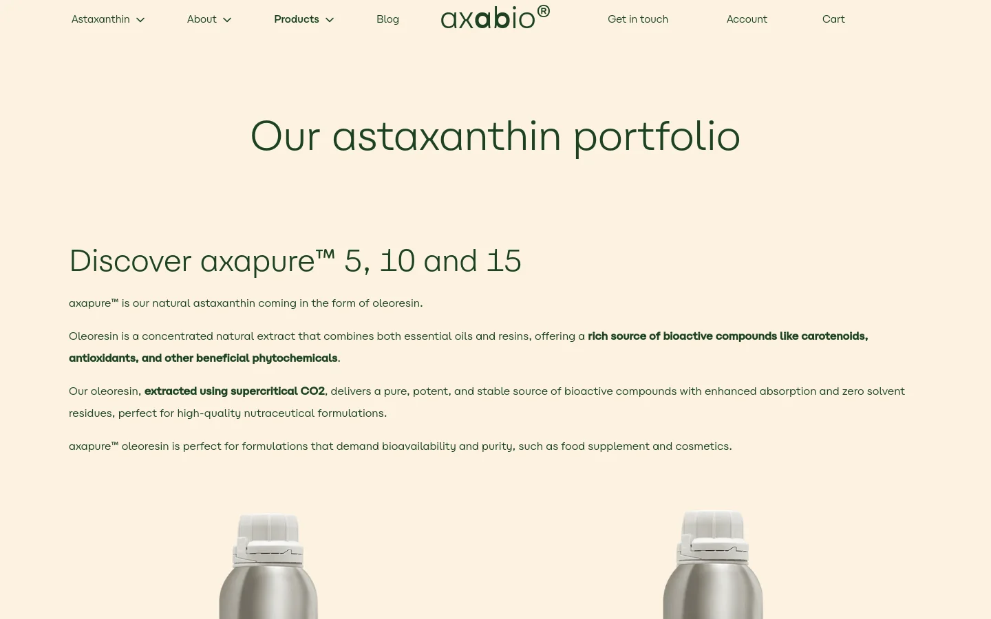 The desktop page features a minimalist cream background with dark green text. A navigation menu sits at the top, followed by a large headline 'Our astaxanthin portfolio' and detailed product descriptions for axapure™ oleoresin. Product images of silver canisters are arranged in a grid below the text.