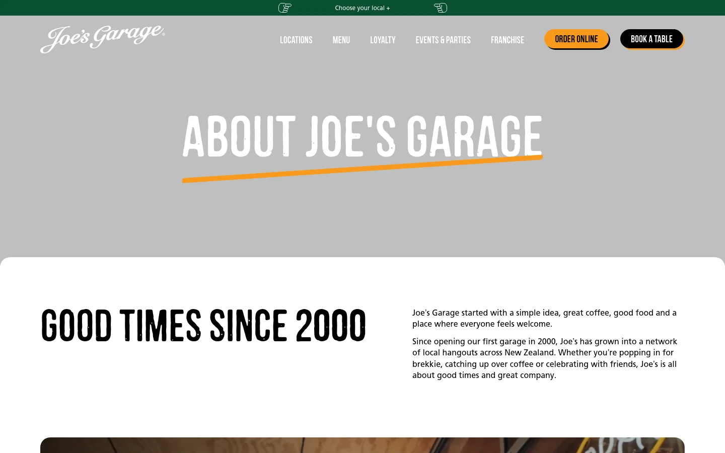The desktop About page features a large grey hero section with the bold white headline 'ABOUT JOE'S GARAGE' underlined in orange. Below, the content is arranged in a clean layout with alternating text blocks and high-quality lifestyle images of food and restaurant settings. The navigation bar includes links for Locations, Menu, and Loyalty, alongside orange 'Order Online' and black 'Book a Table' buttons.