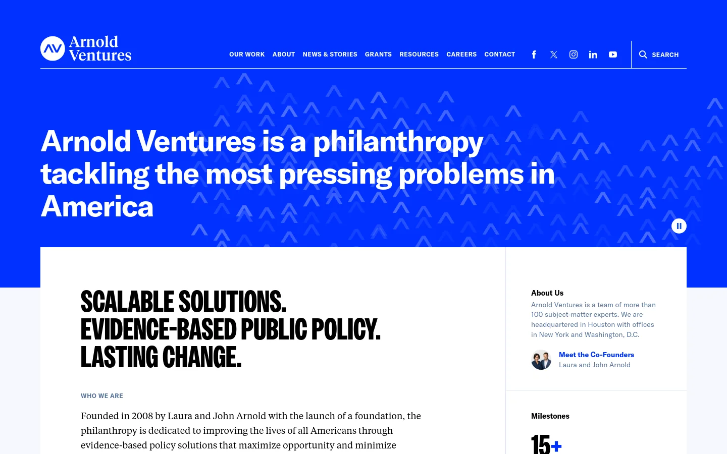 The desktop homepage features a bold blue hero section with white text stating Arnold Ventures is a philanthropy tackling America's most pressing problems, set against a pattern of white chevrons. Below, a clean white section contains large, black sans-serif headlines and detailed text about the organization's mission and history. A navigation bar at the top includes links for Our Work, About, News & Stories, Grants, Resources, Careers, and Contact, alongside social media icons and a search tool.