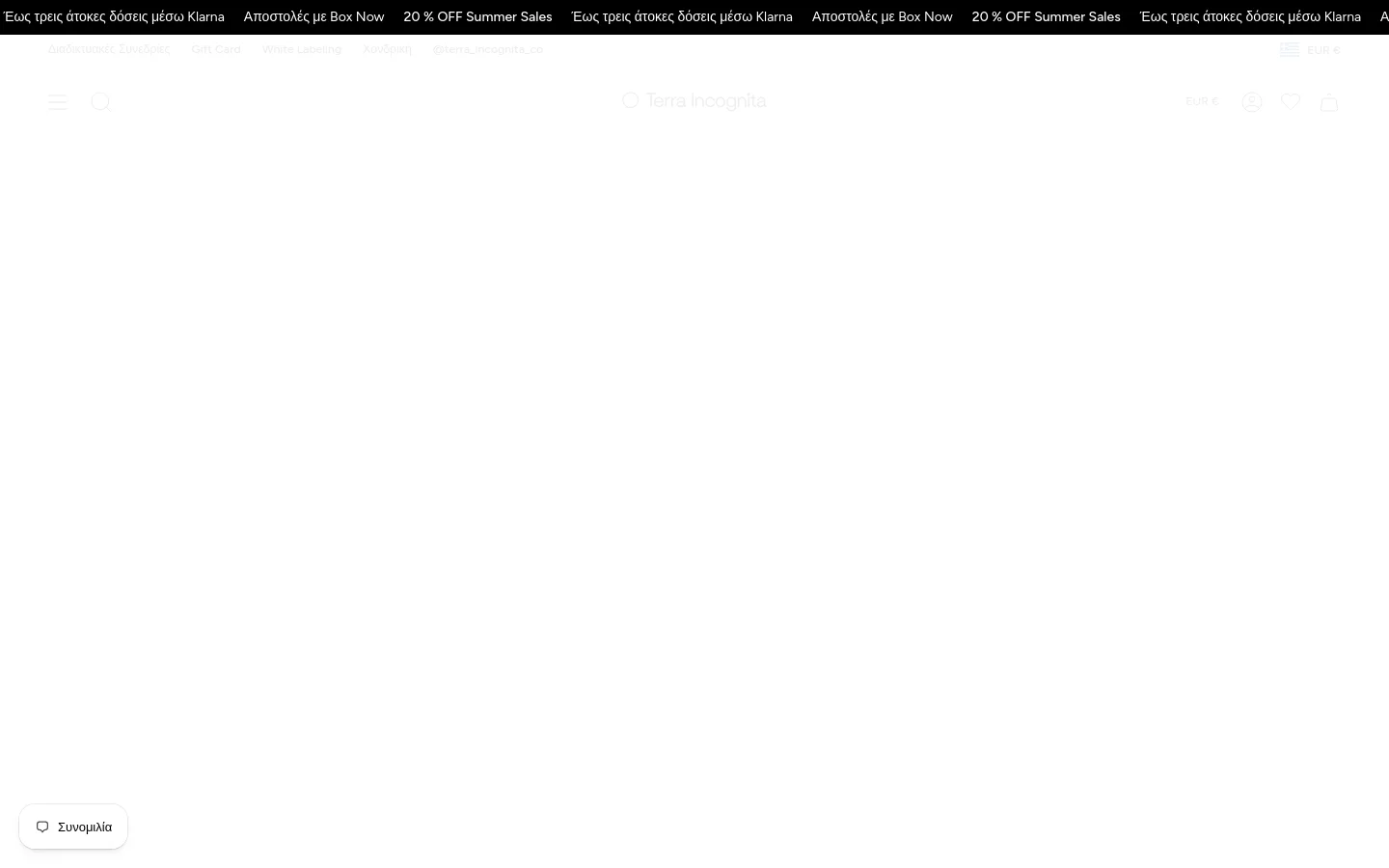 The desktop version of the 'About Us' page features a clean, minimalist layout with a white background and dark text. A centered headline 'About Us' is followed by several paragraphs of Greek text, with a large hero image at the bottom showing a close-up of various rose quartz and clear quartz crystals. The navigation bar includes links for Life Coaching, White Labeling, and Gift Cards, alongside a search icon and shopping bag.