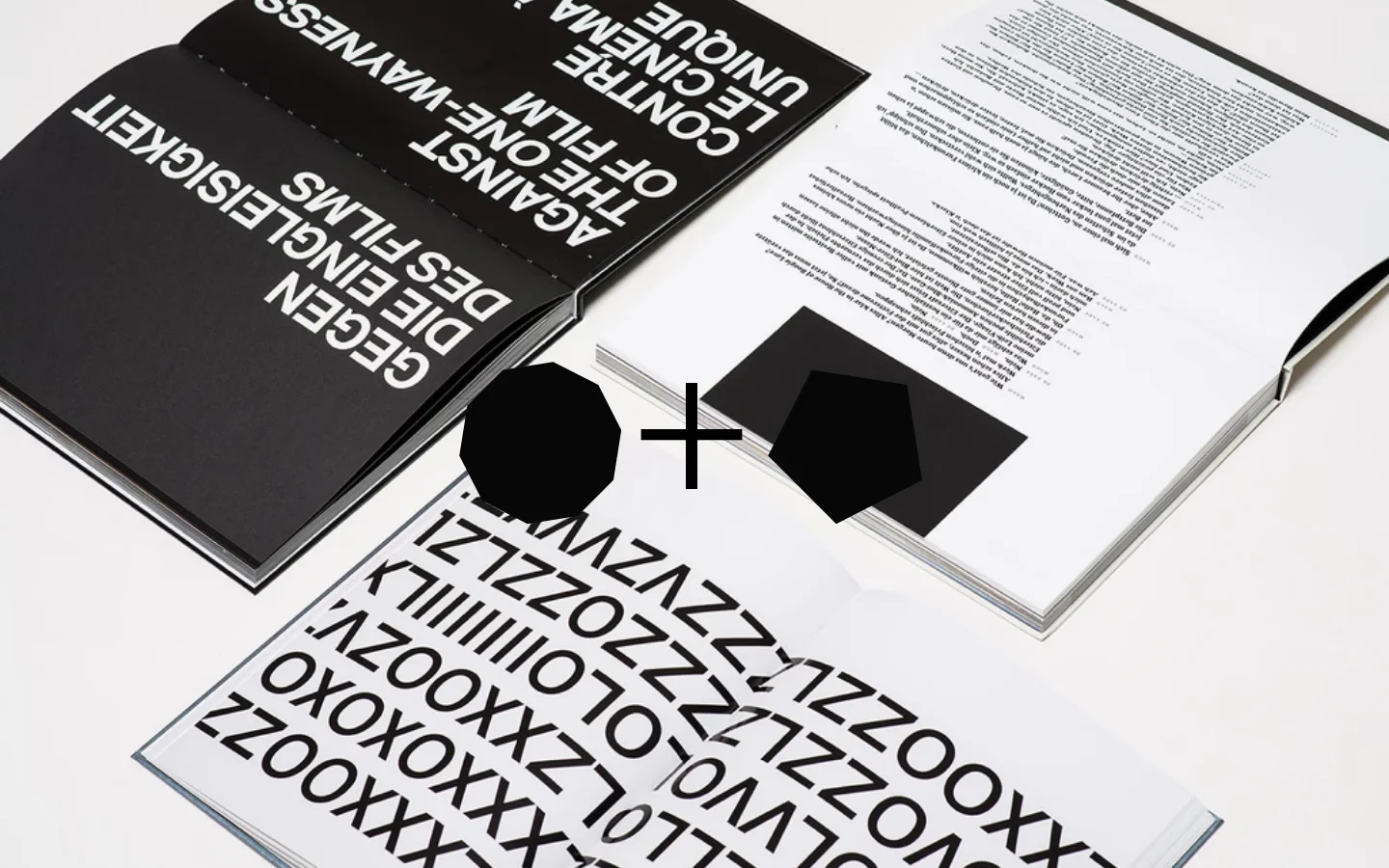 The desktop homepage features a minimalist white background with the brand name 'Heimann + Schwantes' at the top. A large, high-angle hero image shows open design books with bold black typography and graphic patterns. The layout is clean and spacious, emphasizing high-quality photography and editorial design.