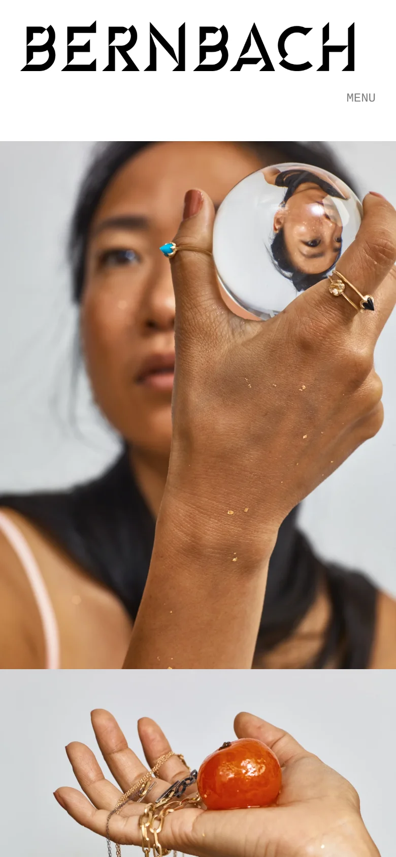 The mobile version displays the large hero image of a person with jewelry and a crystal ball, but the navigation is condensed into a 'MENU' text link. The layout is vertically stacked, focusing on high-quality imagery and the prominent black 'BERNBACH' brand header.