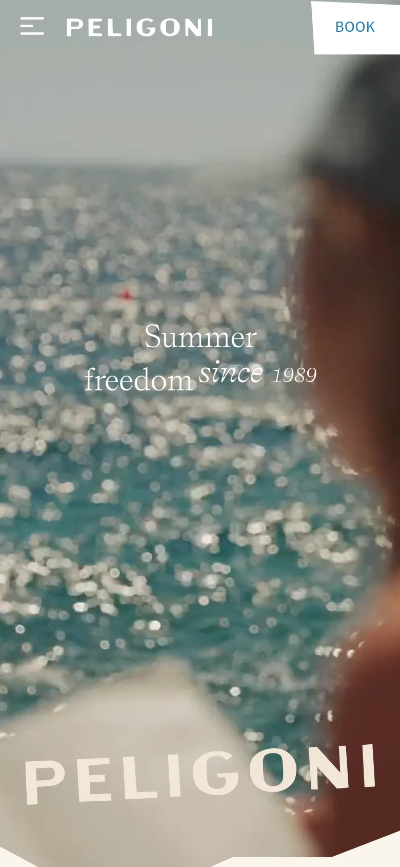 The mobile version presents a vertically oriented view of the hero imagery with a blurred foreground. The 'PELIGONI' brand name and 'Summer freedom since 1989' text are centered, and the navigation is condensed into a hamburger menu icon on the left with a 'BOOK' button on the right.