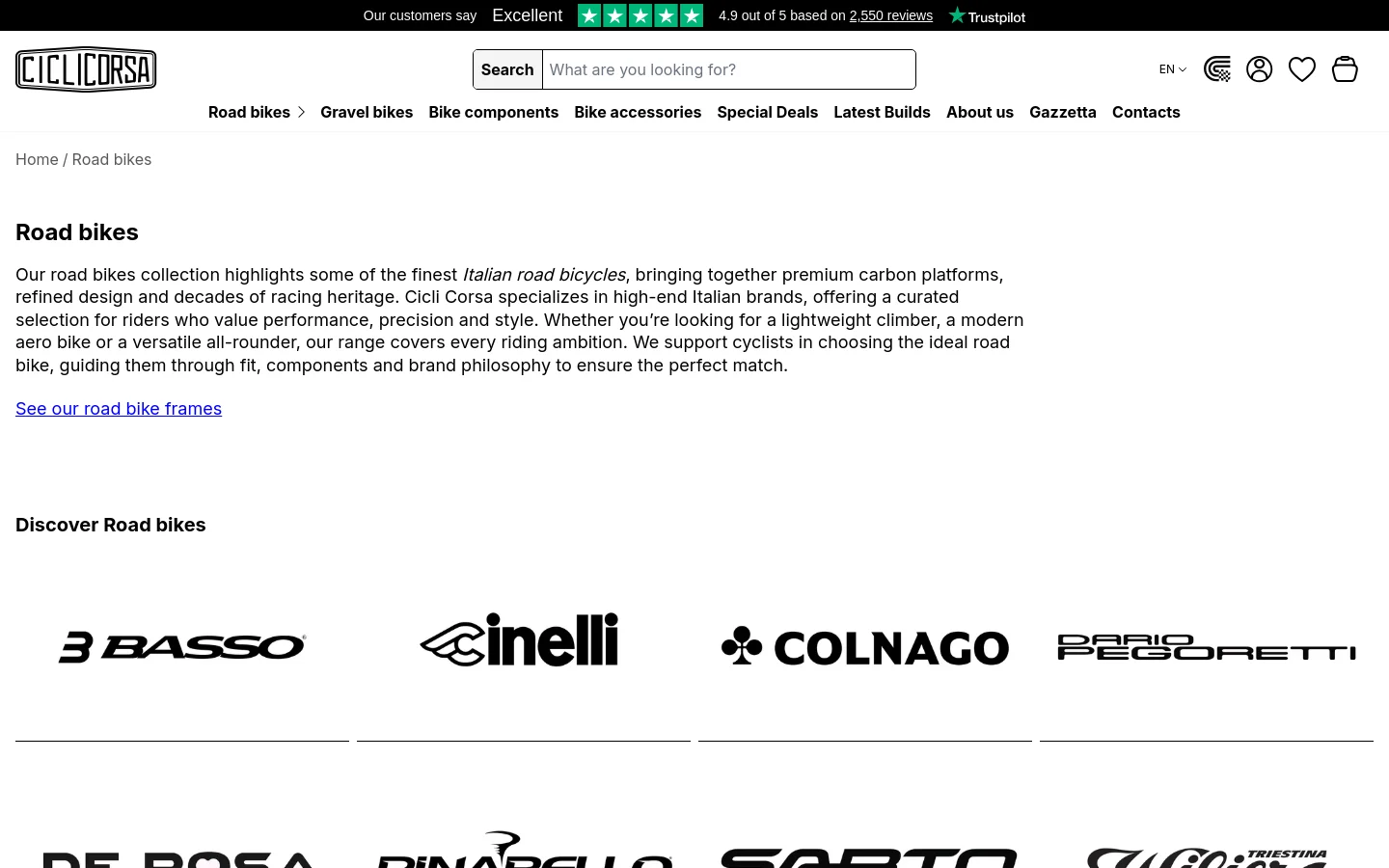 Desktop view of the Road Bikes collection page featuring a clean white background and black text. The header includes the Cicli Corsa logo, a search bar, and navigation links for Road bikes, Gravel bikes, and more. Below the introductory text, a 'Discover Road bikes' section displays large black brand logos for Basso, Cinelli, Colnago, and Dario Pegoretti in a horizontal grid.