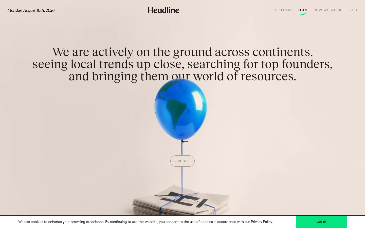 The desktop page features a minimalist design with a large headline about global presence over a central image of a blue balloon shaped like a globe lifting a stack of newspapers. A navigation bar at the top includes links for Portfolio, Team, How We Work, and Blog, while a 'Scroll' button sits below the hero text.