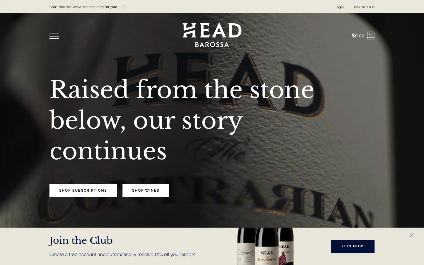 The desktop homepage features a large hero image of a wine bottle label with the headline 'Raised from the stone below, our story continues' and two primary buttons: 'SHOP SUBSCRIPTIONS' and 'SHOP WINES'. A minimalist navigation bar at the top includes a menu icon, the 'HEAD BAROSSA' logo, and a shopping bag icon. A promotional pop-up at the bottom invites users to 'Join the Club' with a dark blue 'JOIN NOW' button.