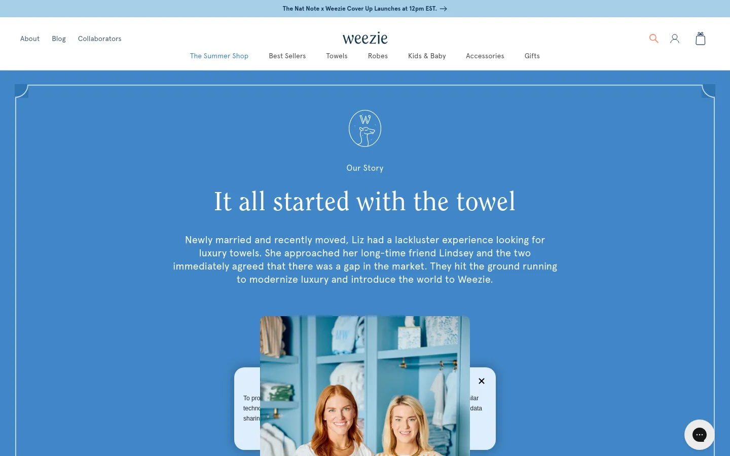 The About page features a blue hero section with a white logo and the headline 'It all started with the towel' followed by a story about the brand's founders. Below the hero, the layout uses a mix of text, lifestyle imagery of two women, and small icons to highlight product features like organic cotton and hand embroidery. The navigation menu at the top includes links for Best Sellers, Towels, Robes, and more against a clean white background.