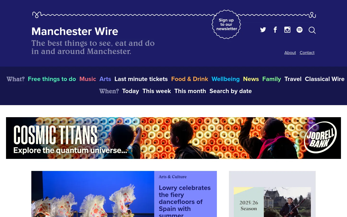 The Manchester Wire homepage features a dark blue header with the site title, social media icons, a newsletter signup button, and a navigation menu categorized by 'What' and 'When'. Below the header, a large colorful banner advertisement for 'Cosmic Titans' spans the width of the page, followed by a grid of article cards with large images and category labels like 'Arts & Culture'.