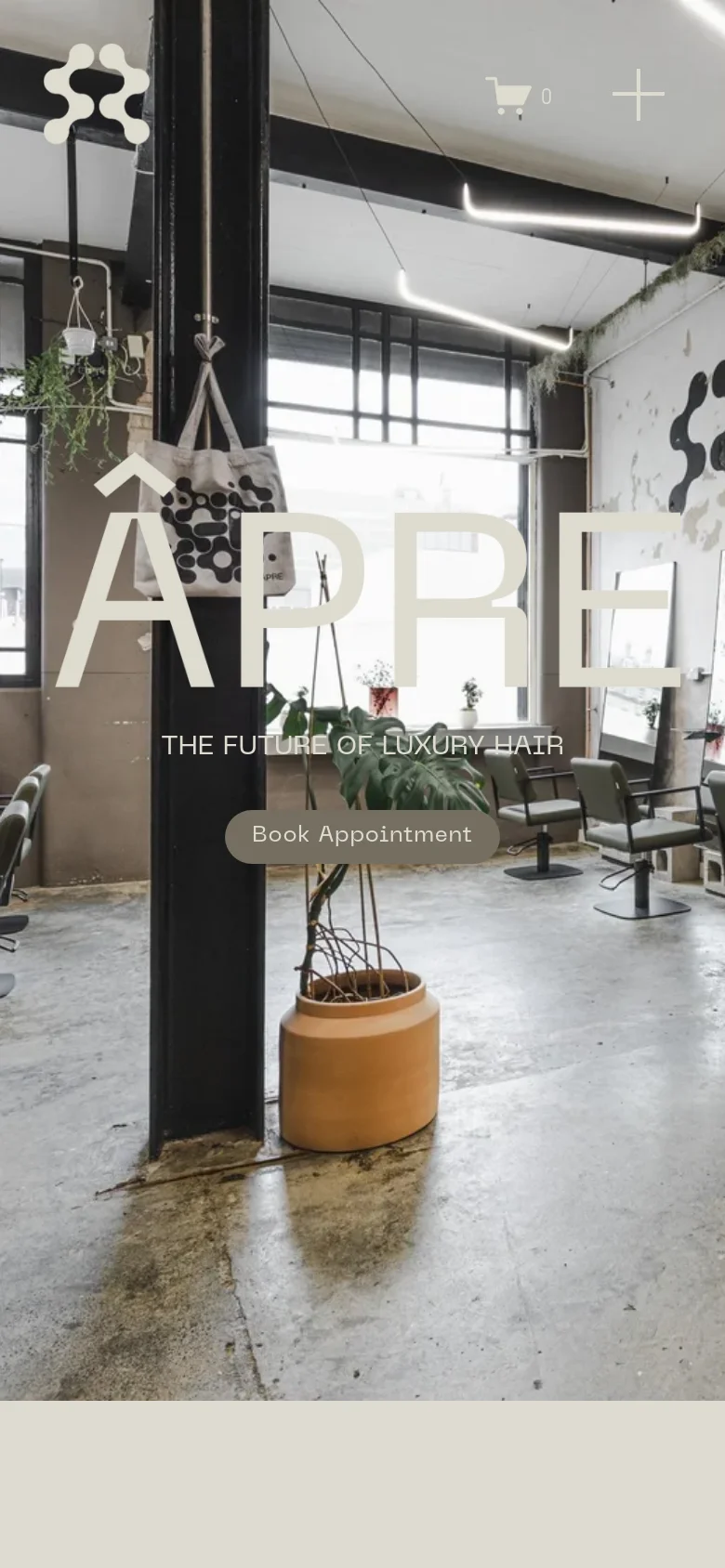 The mobile version presents a vertically oriented hero image of the salon interior, with the 'ÂPRE' logo and 'THE FUTURE OF LUXURY HAIR' headline centered. The layout is simplified, featuring a prominent 'Book Appointment' button in the middle of the screen and a top header containing the logo, a shopping cart icon, and a plus icon.