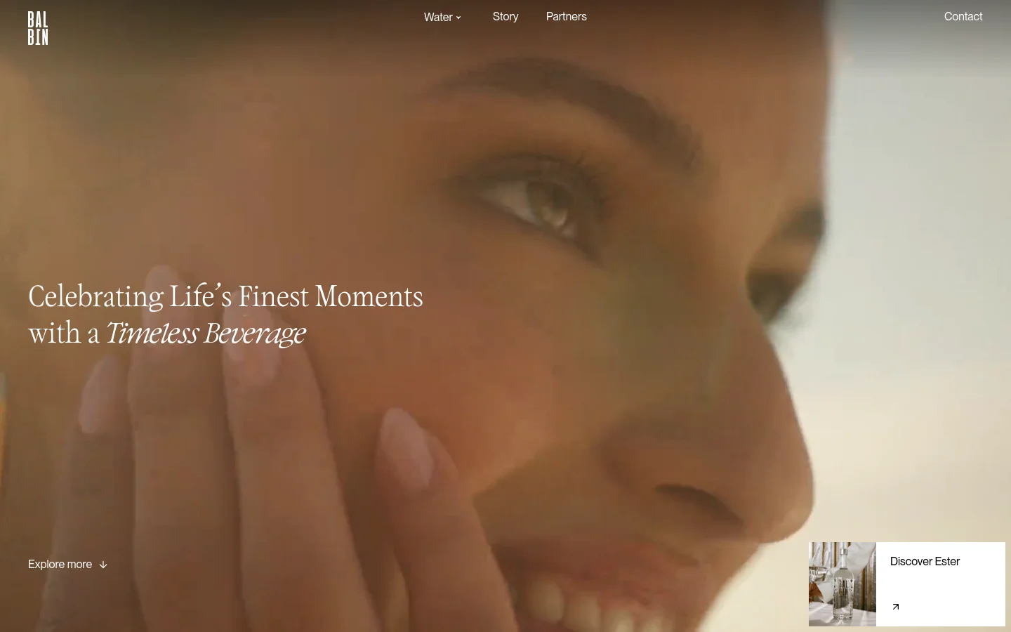 The desktop homepage features a large, warm-toned hero image of a woman's face with the headline 'Celebrating Life’s Finest Moments with a Timeless Beverage'. A navigation menu at the top includes links for Water, Story, Partners, and Contact, while a 'Discover Ester' call-to-action box sits in the bottom right corner.