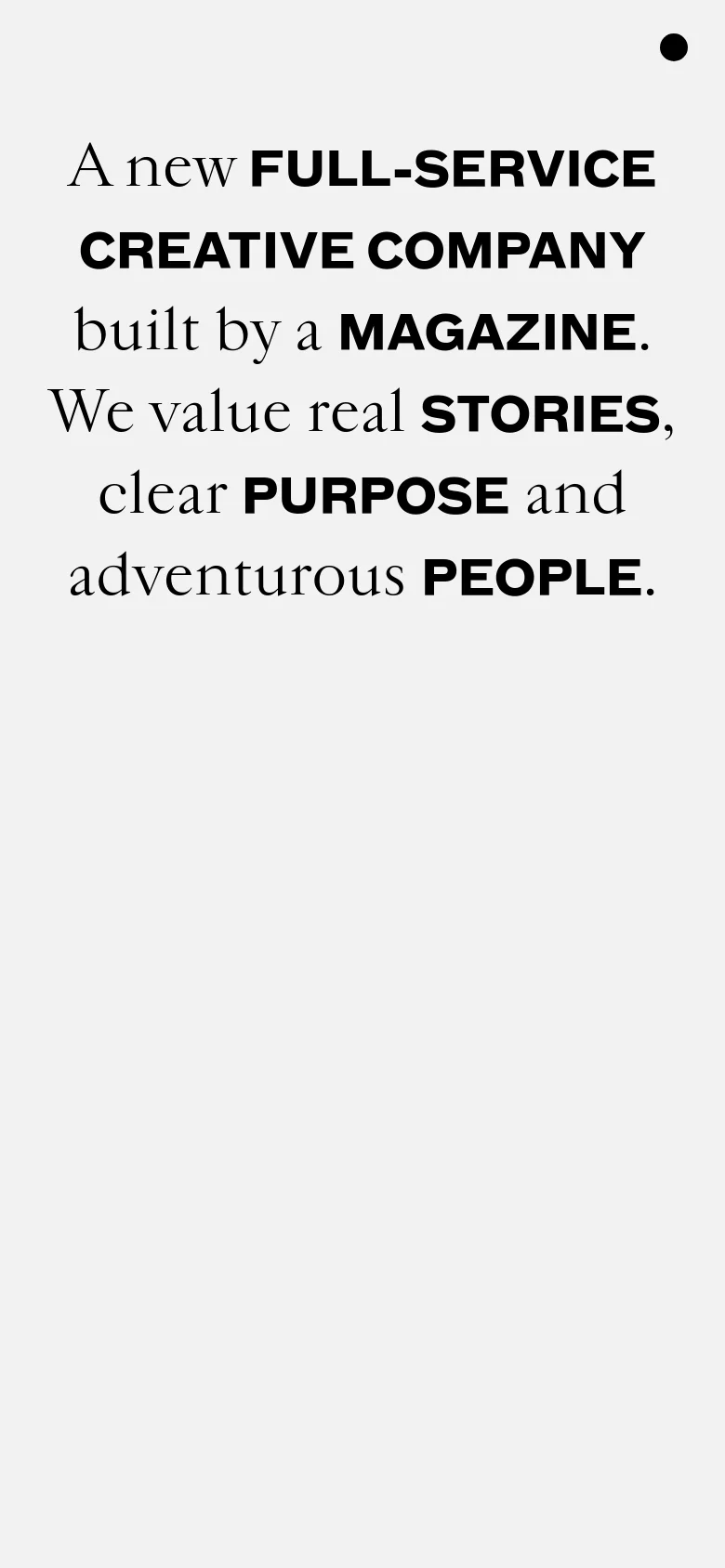 The mobile version presents a vertically stacked, minimalist layout with a focus on large, high-contrast typography. The headline 'A new FULL-SERVICE CREATIVE COMPANY built by a MAGAZINE' dominates the screen in bold black text against a light grey background, with the hero image appearing below the main text block.