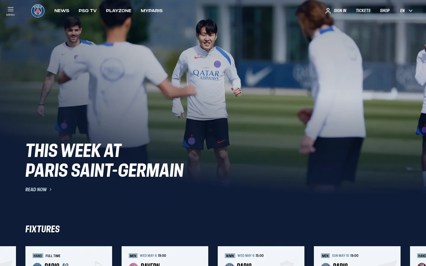 The desktop homepage features a large hero image of Paris Saint-Germain players training on a field, overlaid with the headline 'THIS WEEK AT PARIS SAINT-GERMAIN' and a 'READ NOW' call to action. A dark blue navigation bar at the top includes the PSG logo, links for News, PSG TV, Playzone, and MyParis, along with Sign In, Tickets, and Shop options. Below the hero section, a 'FIXTURES' area displays match cards with team logos and scores against a white background.