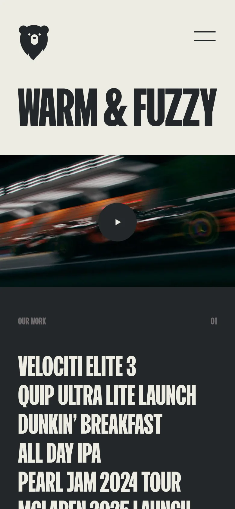 The mobile version maintains the cream and black color scheme but uses a simplified layout with a hamburger menu icon at the top right. The large 'WARM & FUZZY' headline is centered above a video player, and the 'Our Work' section follows with a vertical list of project titles.
