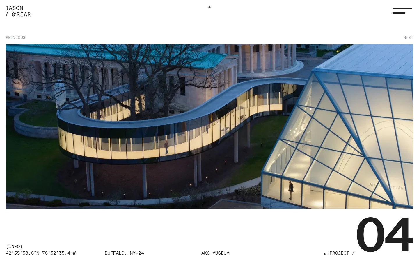 A minimalist portfolio website for architectural photographer Jason O'Rear featuring a large, full-width hero image of a modern glass walkway at the AKG Museum. The layout uses a clean white background with black typography, displaying project details like geographic coordinates and location at the bottom. Navigation includes 'Previous' and 'Next' controls and a hamburger menu in the top right.