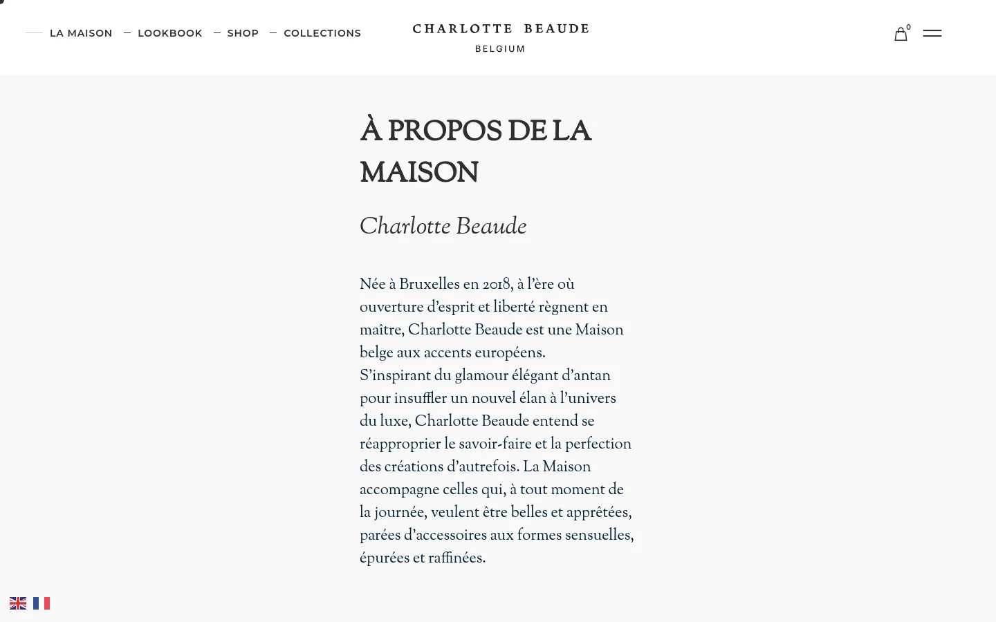 The desktop page features a minimalist white background with elegant serif typography. A large headline reads 'À PROPOS DE LA MAISON' followed by introductory text about the Belgian luxury brand, accompanied by high-quality lifestyle imagery of accessories and portraits. The navigation menu is spread horizontally across the top, including links for La Maison, Lookbook, Shop, and Collections.