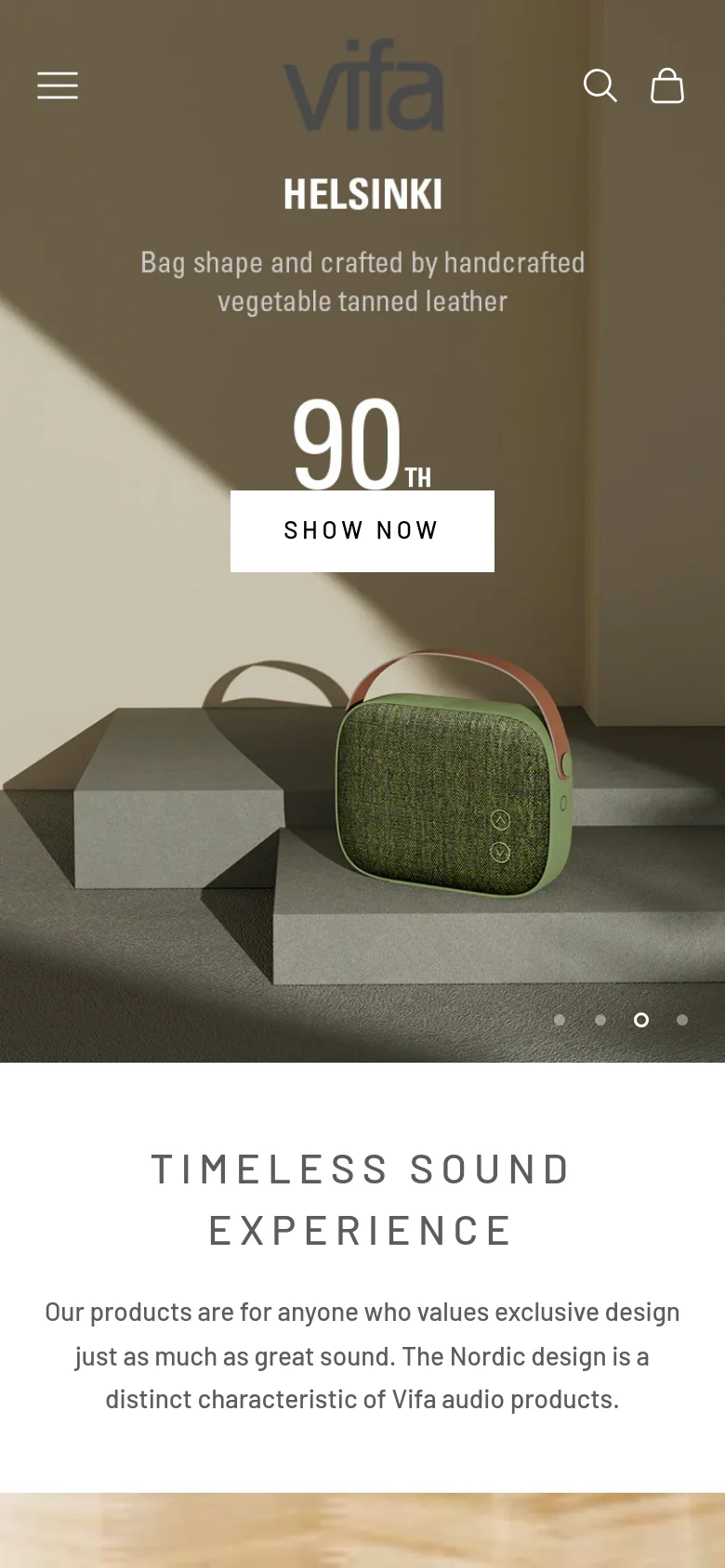 The mobile version uses a condensed layout with a hamburger menu and search/cart icons in the header. The hero section is vertically stacked, featuring the Helsinki speaker, the '90th Anniversary' branding, and a prominent 'SHOW NOW' button centered on the screen. The 'TIMELESS SOUND EXPERIENCE' text follows below, optimized for vertical scrolling on a smaller screen.