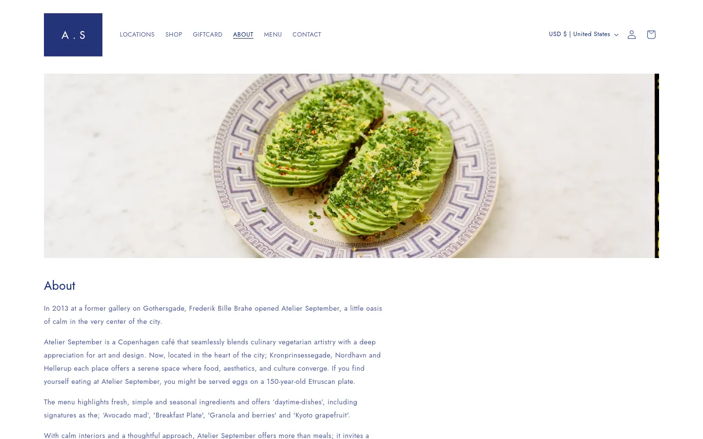 The desktop About page features a minimalist white layout with a large hero image of sliced avocado on a decorative patterned plate. A clean navigation bar at the top includes links for Locations, Shop, Giftcard, About, Menu, and Contact. The text content is arranged in a single column below the hero image, detailing the café's history and team.