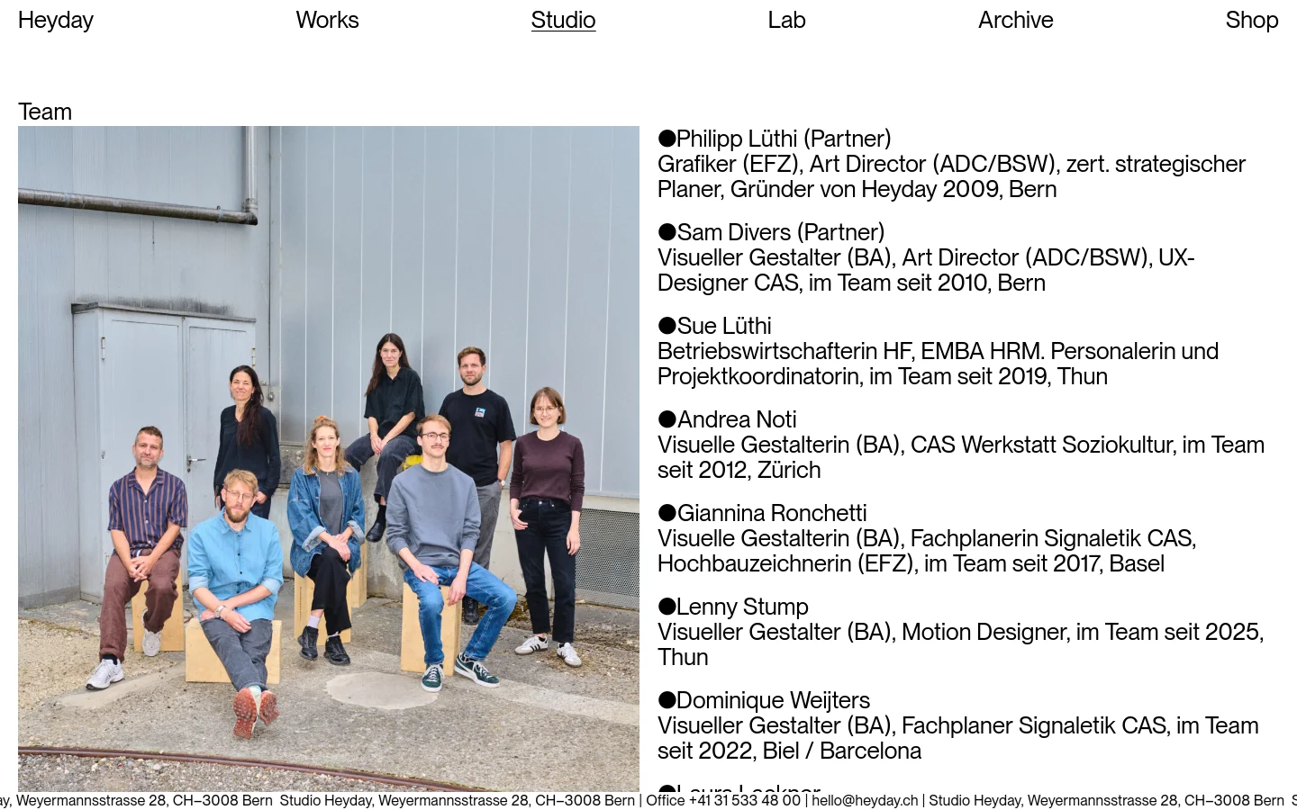 The Studio page features a large group photo of the Heyday team sitting and standing outdoors against a grey industrial wall. To the right of the photo, a list of team members is displayed with their names, roles, and professional credentials in black text on a white background. The top navigation bar includes links for Works, Studio, Lab, Archive, and Shop.