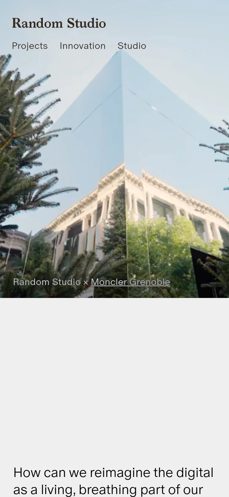 The mobile version presents a vertically oriented version of the hero image, showing the mirrored architecture and trees. The navigation links are stacked below the logo, and the headline 'How can we reimagine the digital as a living, breathing part of our physical world?' is visible at the bottom of the screen.