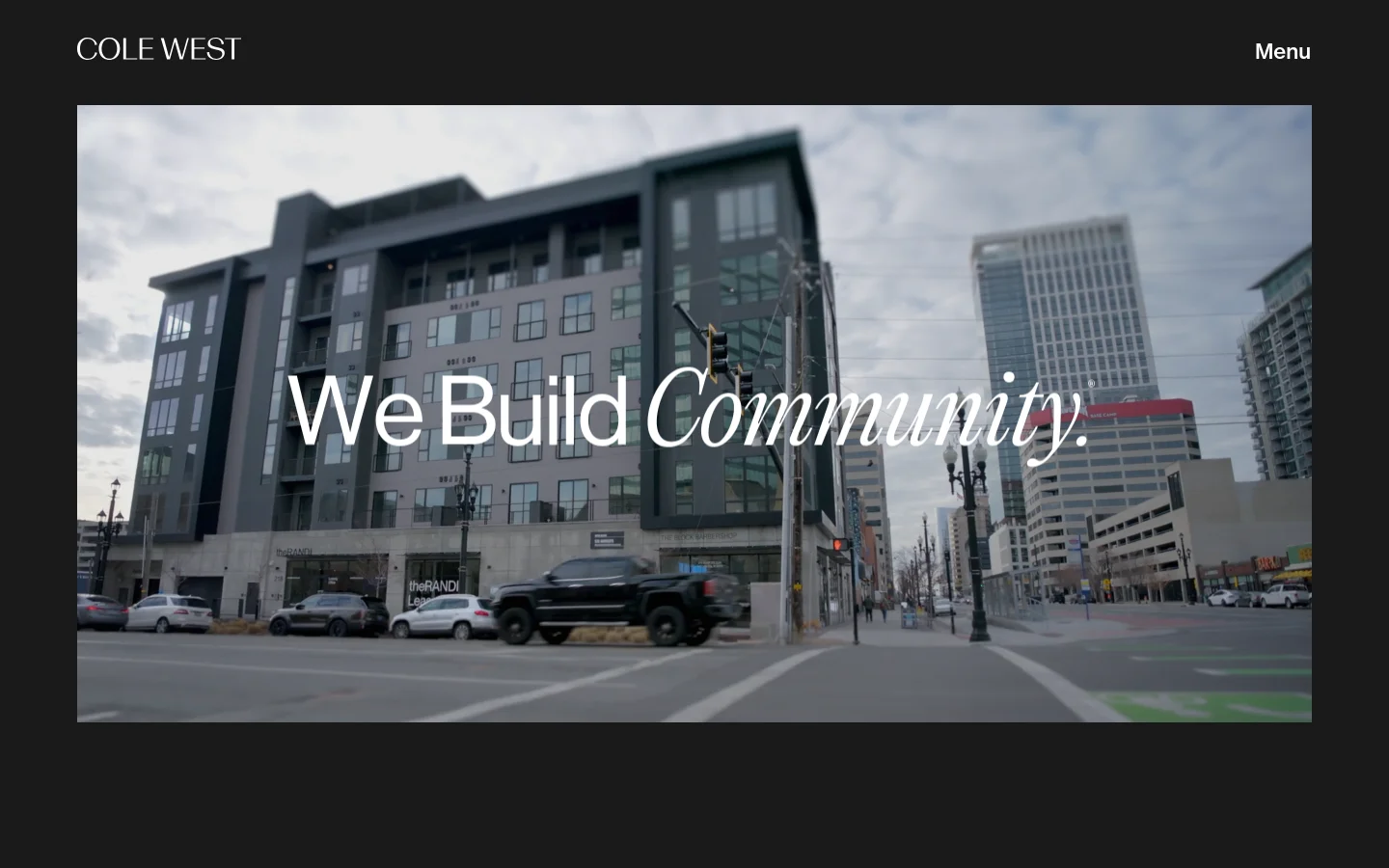 The desktop homepage features a dark header with 'COLE WEST' on the left and 'Menu' on the right. A large hero image shows a modern urban streetscape with multi-story buildings and a black pickup truck, overlaid with the large white headline 'We Build Community.' Below the hero, the layout transitions into a vertical list of expertise areas including Homebuilding, Land Company, Multifamily, Retail, and Commercial Contracting, each featuring a large photographic background, descriptive text, and 'Learn More' buttons.