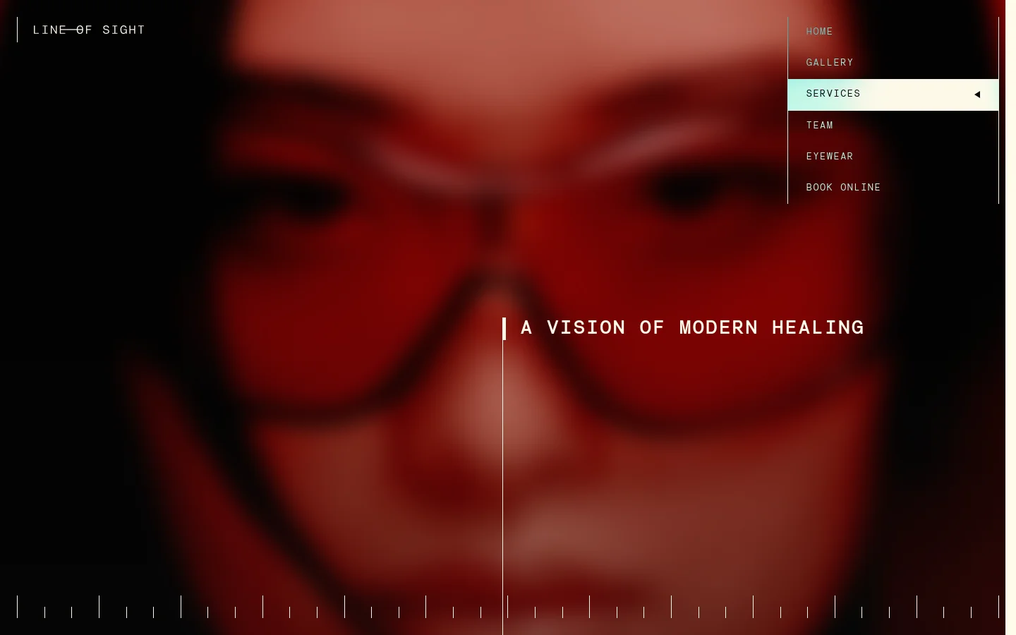 The desktop page features a dark, cinematic hero section with a blurred close-up of a person wearing red glasses and the headline 'A VISION OF MODERN HEALING'. A navigation menu is positioned on the right side with links for Home, Gallery, Services, Team, Eyewear, and Book Online. The layout uses high-contrast white text against a deep red and black background.