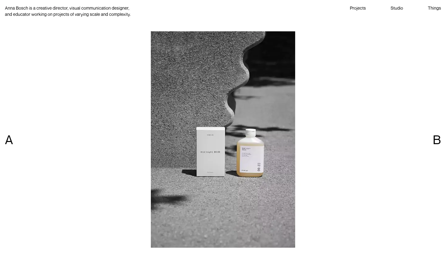 The desktop homepage features a minimalist design with a large central hero image of a product against a textured grey background. Navigation links for Projects, Studio, and Things are positioned in the top right, while a brief professional bio is in the top left, all set against a clean white background.