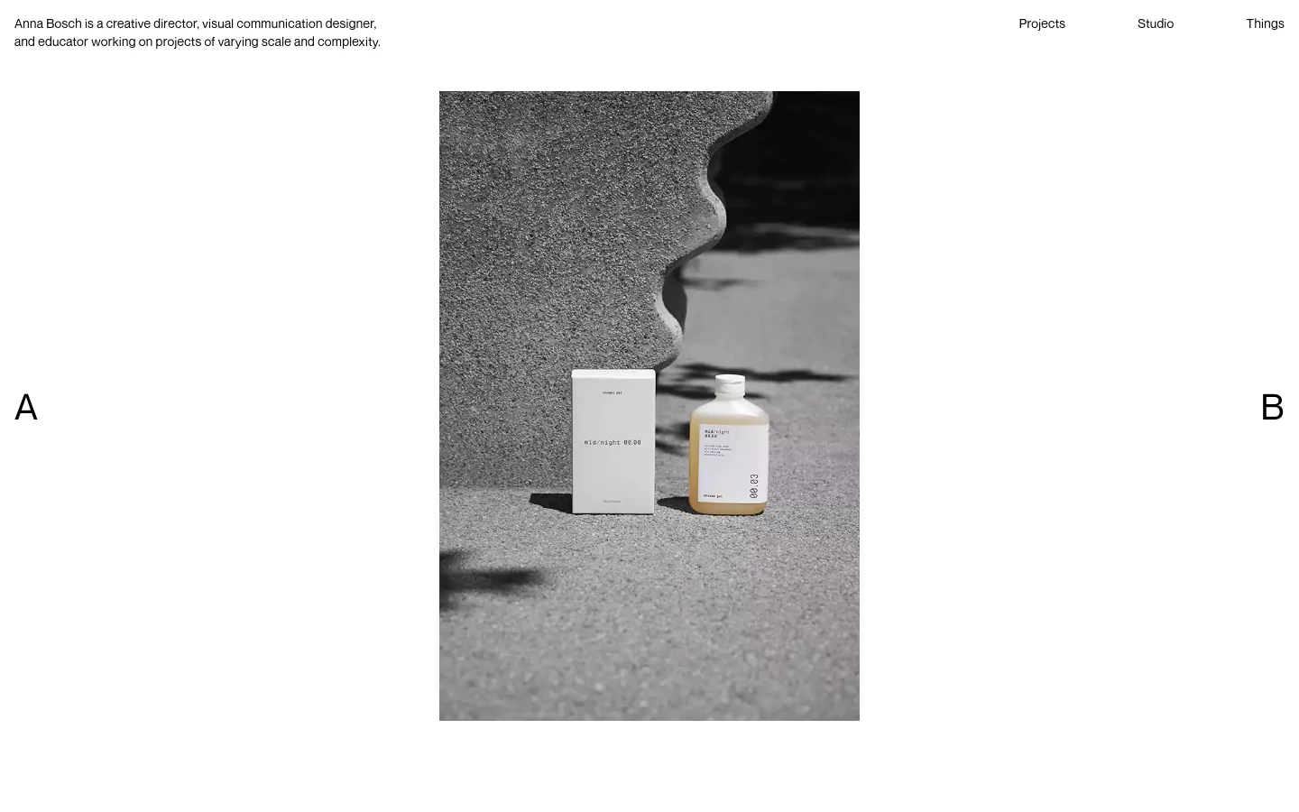 The desktop homepage features a minimalist design with a large central hero image of a product against a textured grey background. Navigation links for Projects, Studio, and Things are positioned in the top right, while a brief professional bio is in the top left, all set against a clean white background.