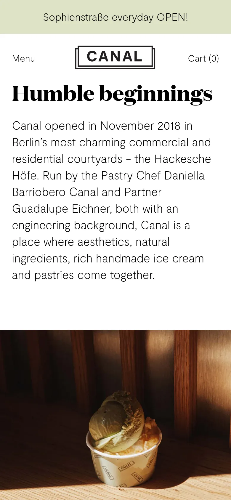 The mobile version maintains the minimalist aesthetic but uses a simplified header with a 'Menu' label on the left and 'Cart (0)' on the right, flanking the central Canal logo. The content is stacked vertically, with the 'Humble beginnings' headline and introductory text appearing above a large, full-width hero image.