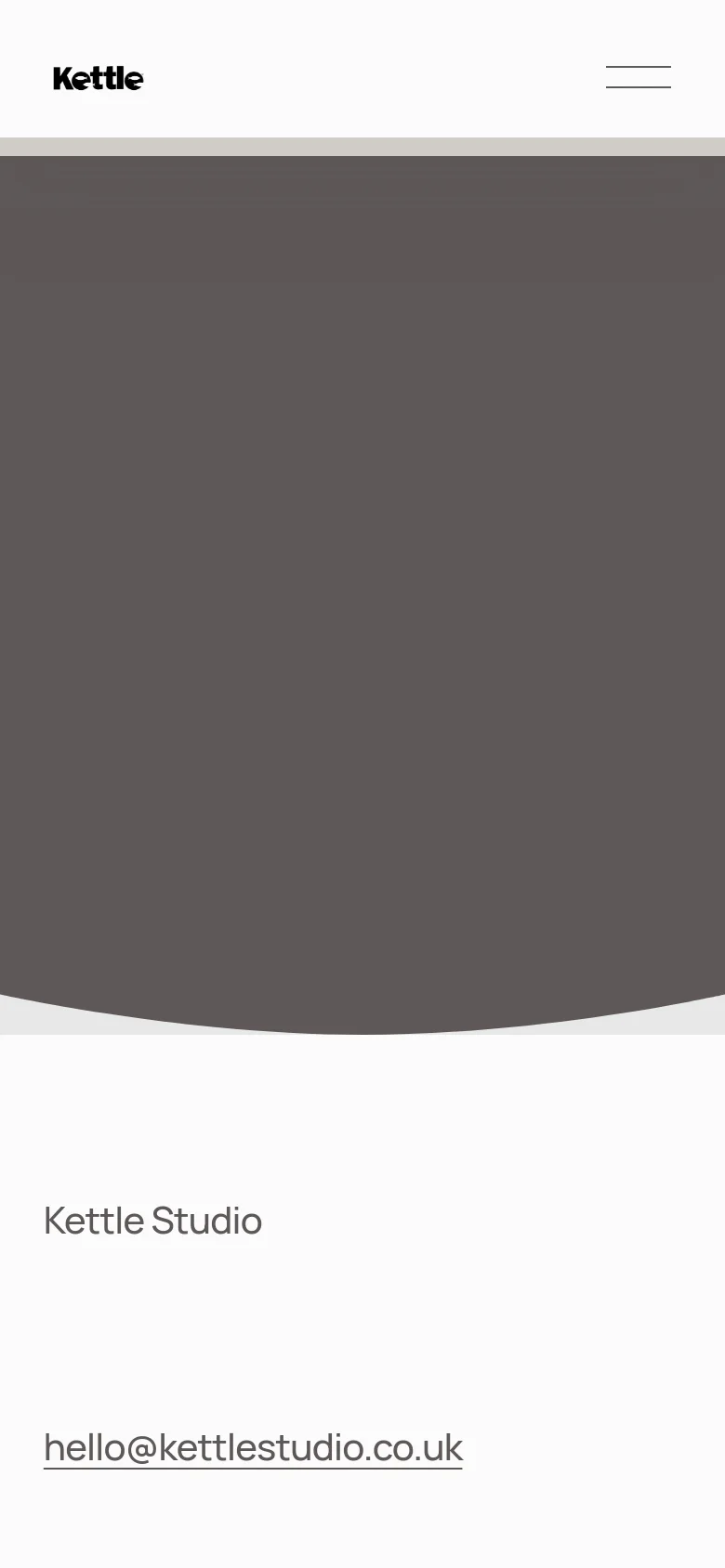 The mobile version maintains the minimalist aesthetic with a simplified header featuring the logo and a hamburger menu icon. The large dark grey hero section is scaled for a vertical viewport, and the portfolio projects are arranged in a single-column vertical stack. The footer remains at the bottom with the studio name and email link.