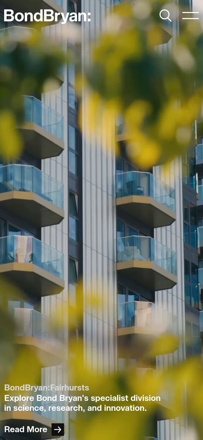 The mobile version presents a vertically oriented, zoomed-in view of the architectural hero image, focusing on building balconies and blurred yellow foliage. The 'BondBryan:' logo is positioned at the top left, while the search and hamburger menu icons are prominent at the top right. The text overlay and 'Read More' button are moved toward the bottom of the screen.