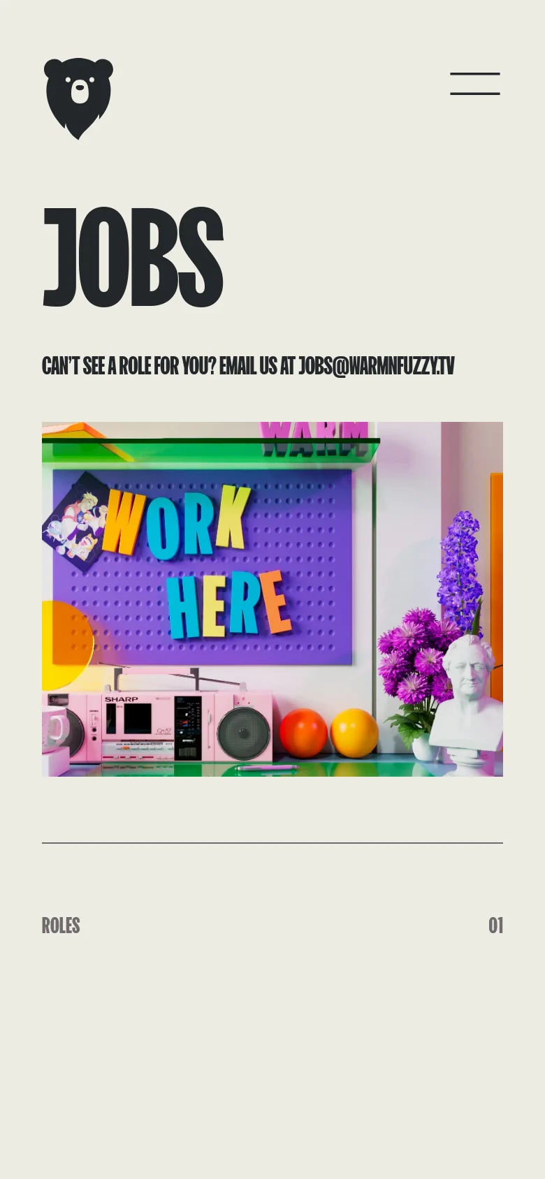 The mobile version maintains the minimalist beige aesthetic but uses a condensed layout. The navigation is tucked into a hamburger menu at the top right, and the large 'JOBS' header and colorful 'WORK HERE' hero image are scaled to fit the narrower screen width.