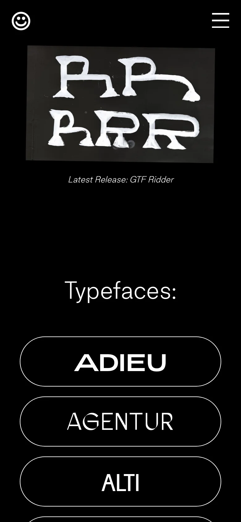 The mobile version uses a black background with a simplified header featuring a smiley face logo and a hamburger menu icon. The hero image of hand-painted white letters is centered and scaled down, followed by the text 'Latest Release: GTF Ridder' and a large 'Typefaces:' heading. The typeface selection is presented as a single-column vertical list of large, pill-shaped buttons.