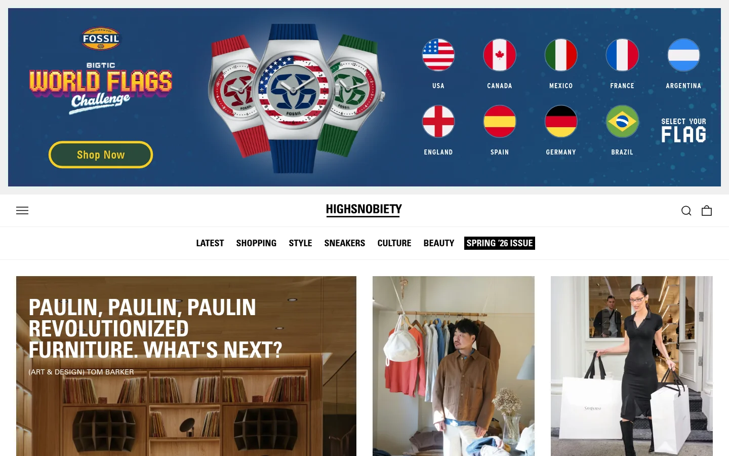 The Highsnobiety homepage features a clean, white layout with a large hero banner at the top showcasing Fossil watches with various national flags against a blue background. Below the banner, a large editorial feature displays a headline about Paulin furniture over a warm-toned image of a modern interior with wooden shelving and a green lounge chair. Navigation links for Latest, Shopping, Style, Sneakers, Culture, and Beauty are centered below the site logo.