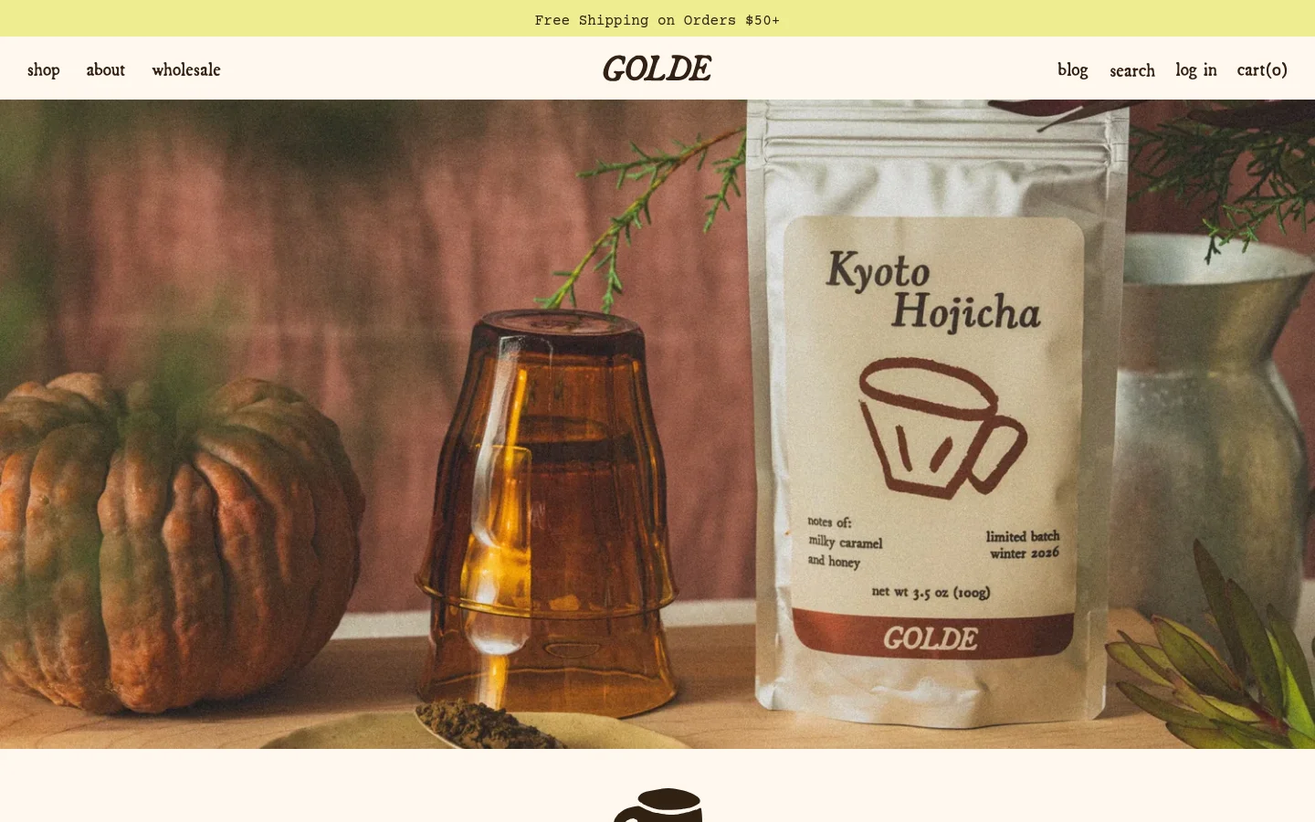The desktop homepage features a wide hero image of Kyoto Hojicha tea packaging next to a pumpkin and amber glassware against a warm, earthy background. A navigation bar at the top includes links for shop, about, wholesale, blog, search, log in, and cart. Below the hero, sections introduce the brand story and a 'Bestsellers' product grid with images of a frother, matcha, and a cookbook.